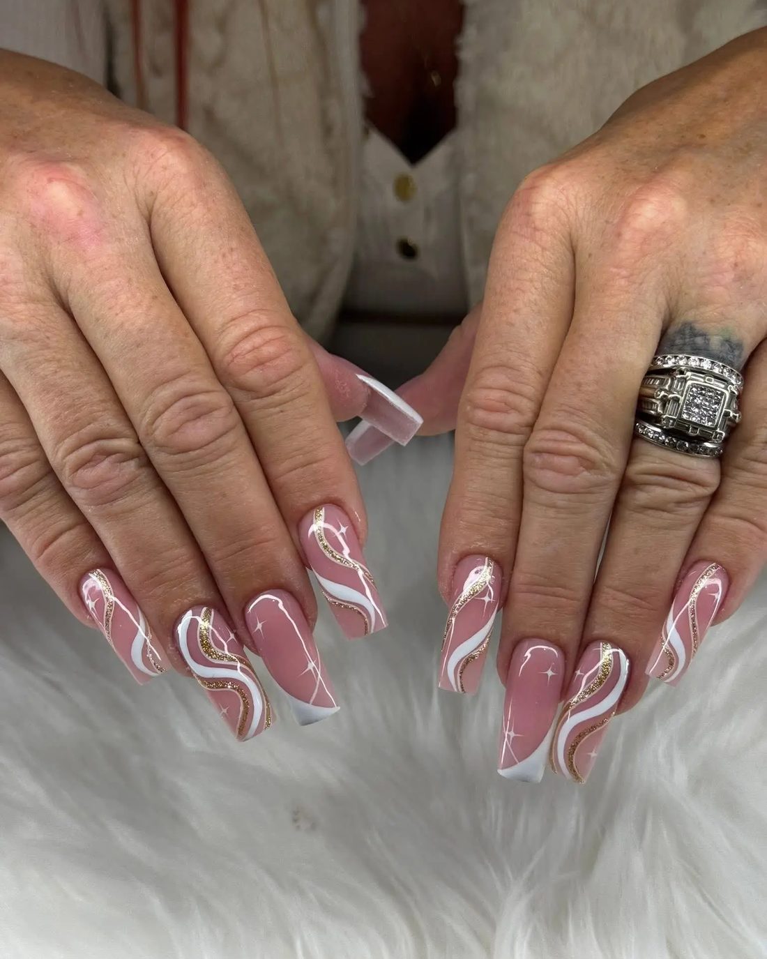 Hand-painted swirl nail art on almond-shaped nails, done at Gloss Nails Bar