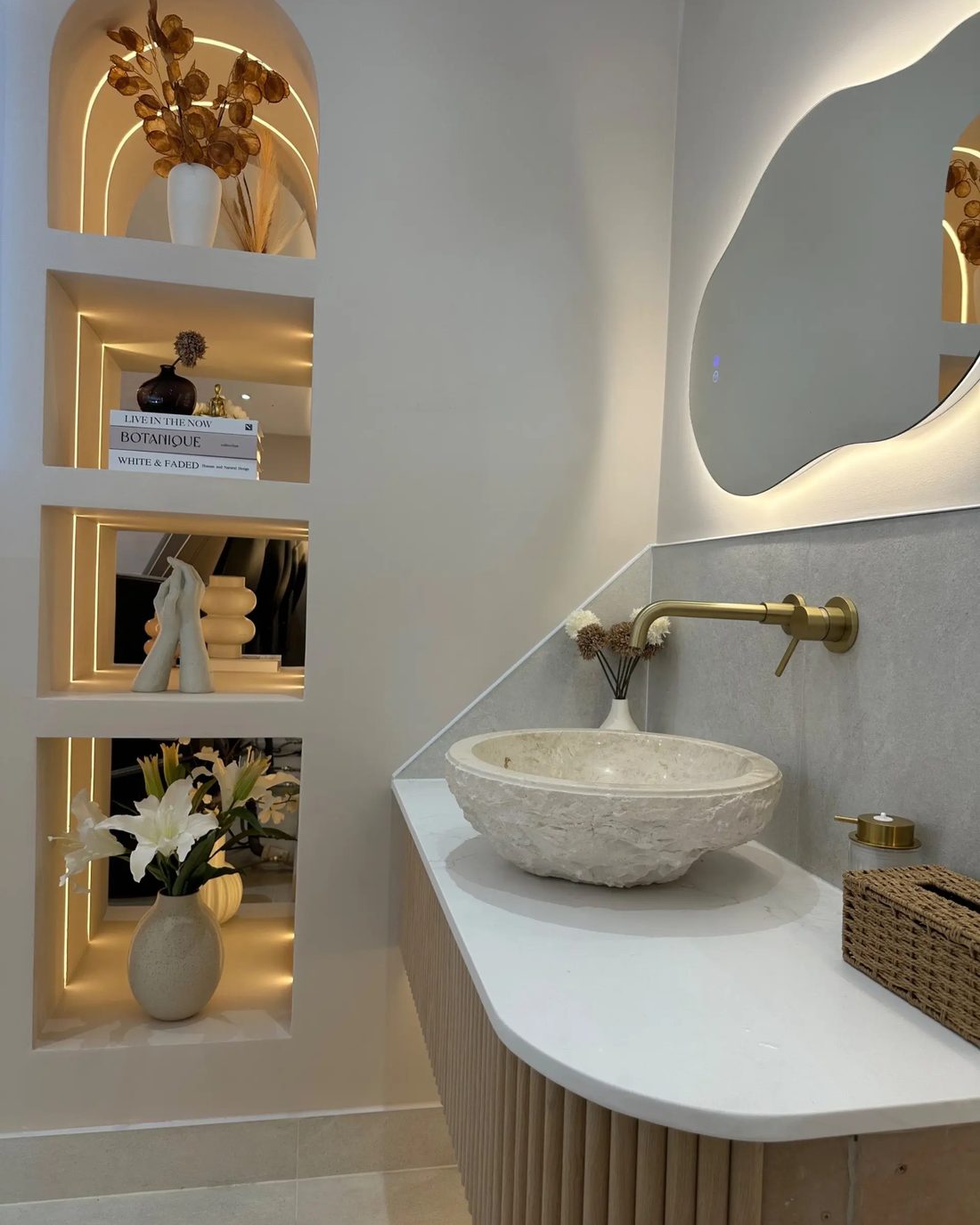 Stone basin and brass tap in an arched alcove inside the salon