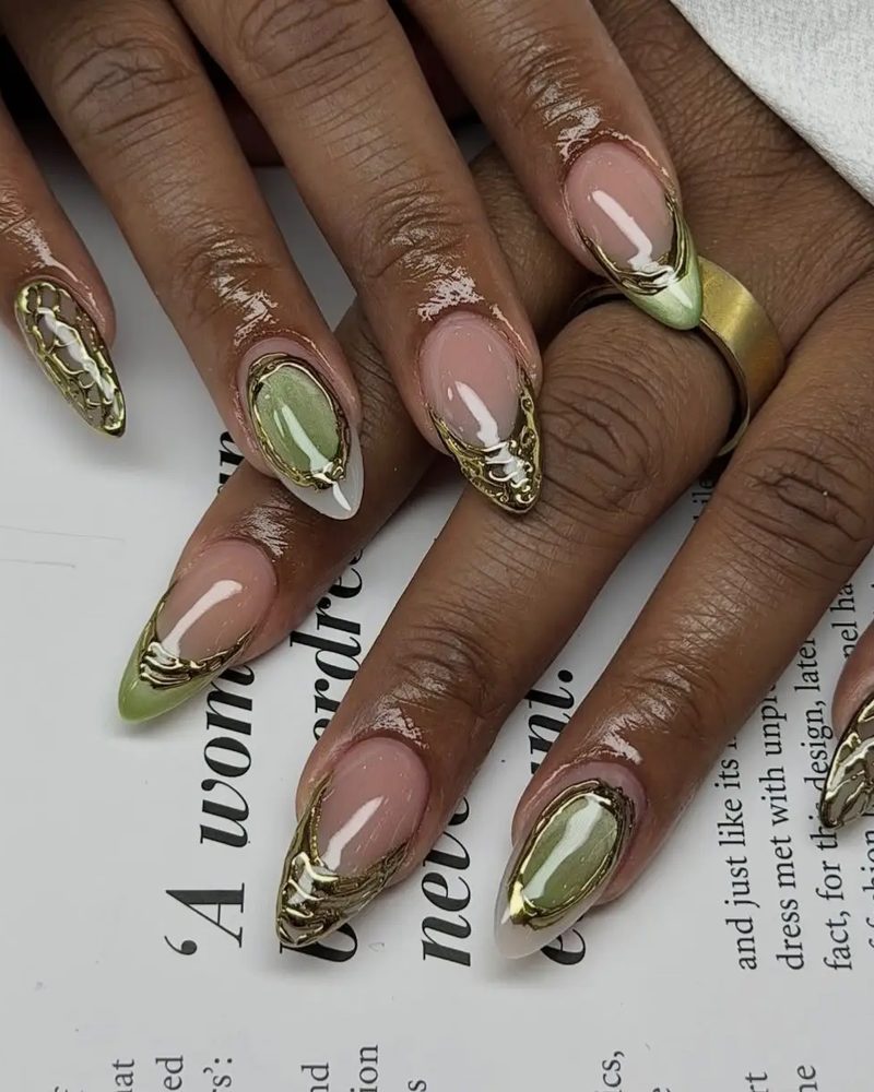Almond nails with gold chrome French tips over a nude base