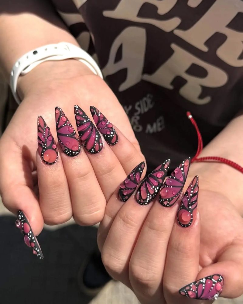 Long stiletto nails with hand-painted pink butterfly wings